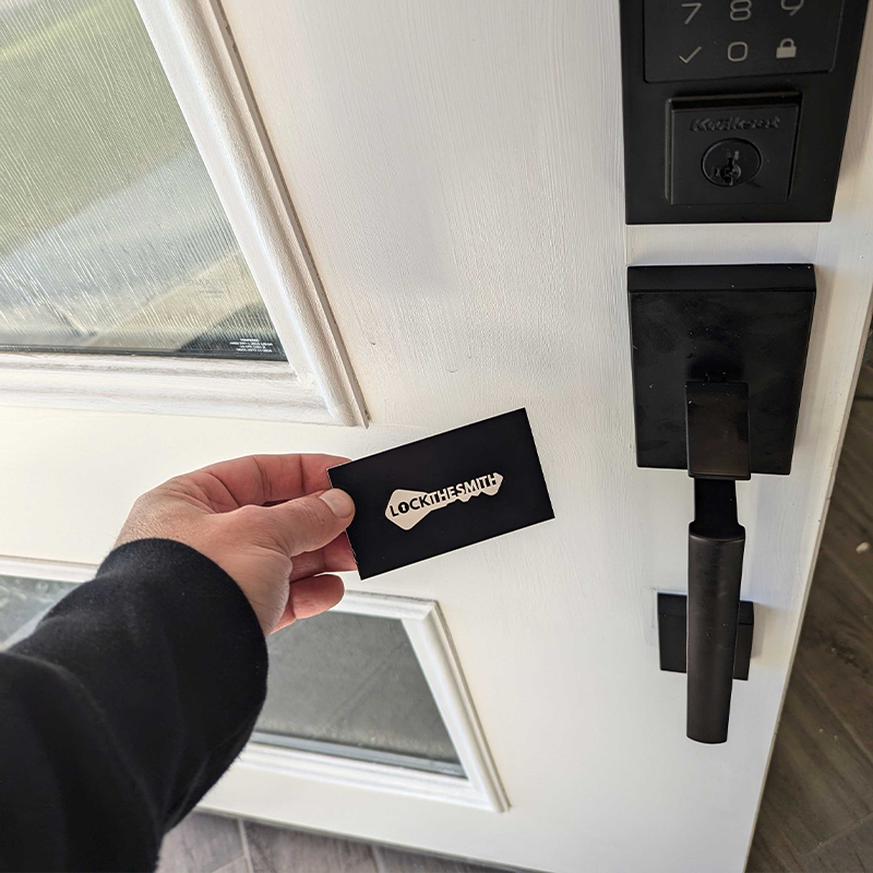 LockTheSmith locksmith holding a branded card next to a commercial-grade door lock in Salt Lake City